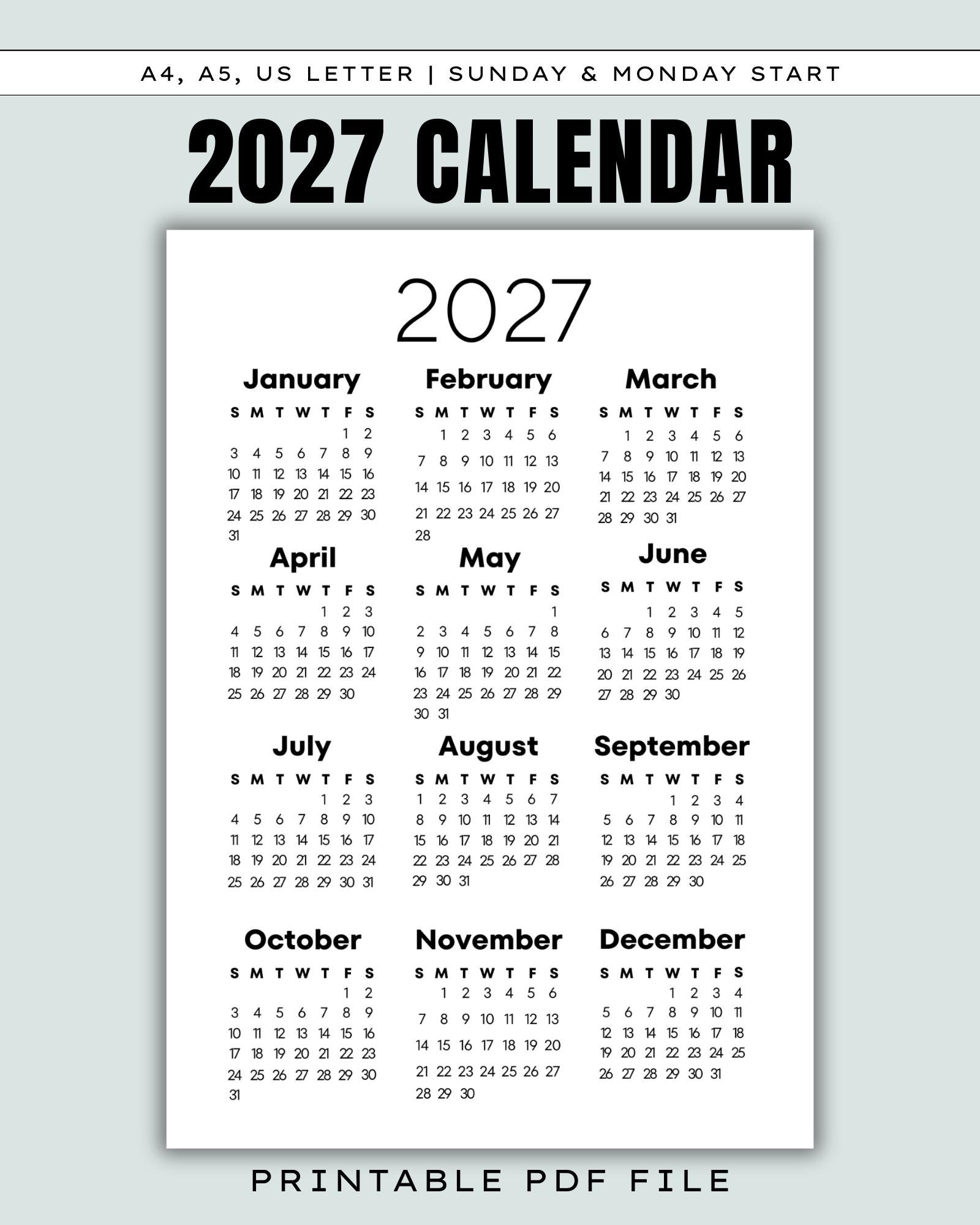 Desk with an open printable calendar spread and colorful sticky notes