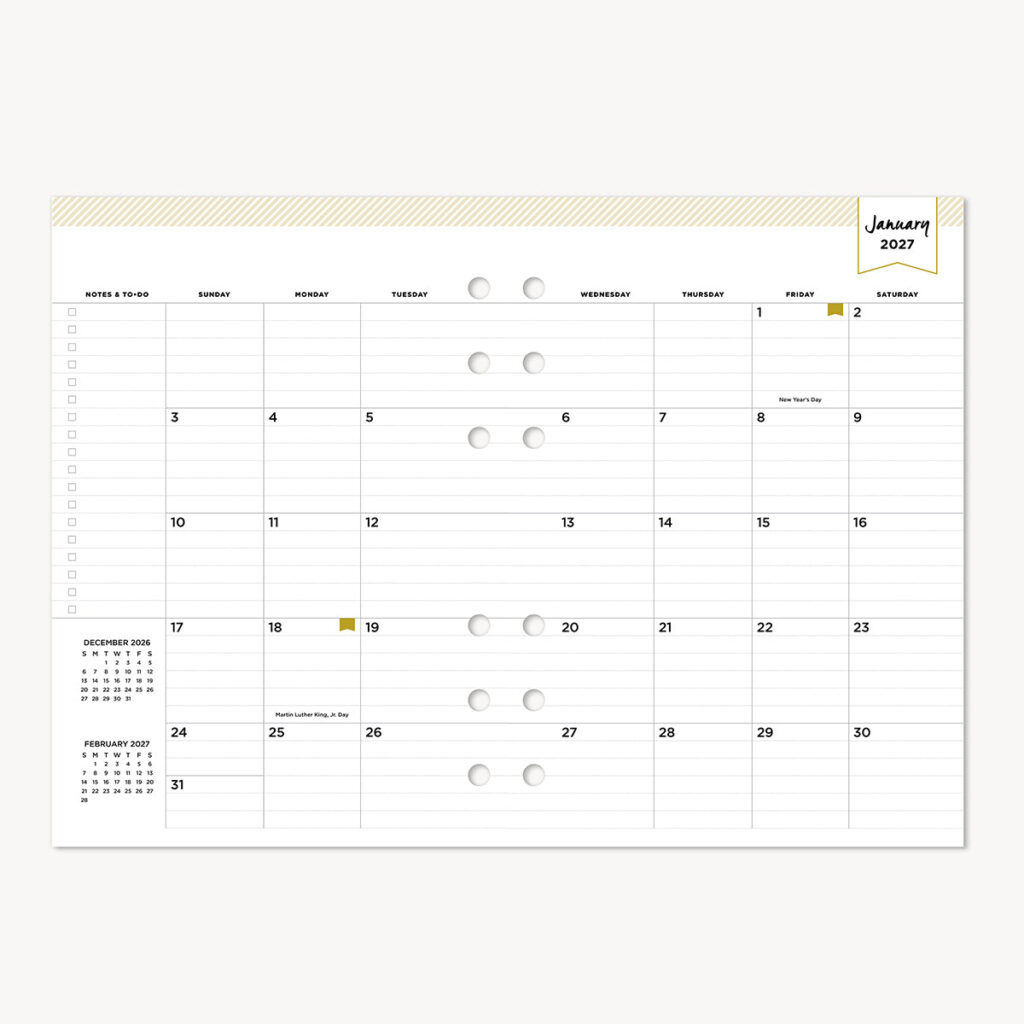 Rows of printable calendar pages spread across a desk